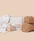 Gift set with a box, towel, hair wrap, make up and toiletry bags on a beige background