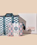 Set of reusable bags with geometric and floral patterns next to a gift box on a beige background